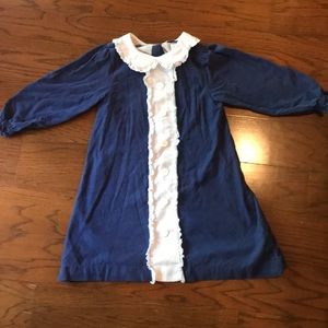 Corduroy navy dress with white ruffle.